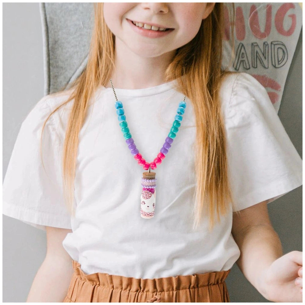 Diamantiny Deco Charms Set showcased by a smiling girl in a white top and brown skirt, wearing a colorful pendant necklace.