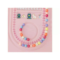 Jewel Design 600 Precious Beads bracelet in blue, pink, yellow, and white on a pink grid background with symbols.
