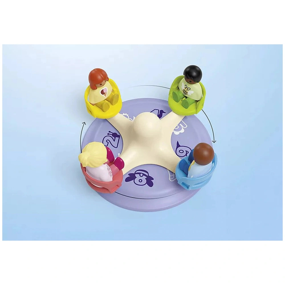 Playmobil Junior Number Merry-Go-Round toy features three abstract figures in white, yellow, and green against a light blue b