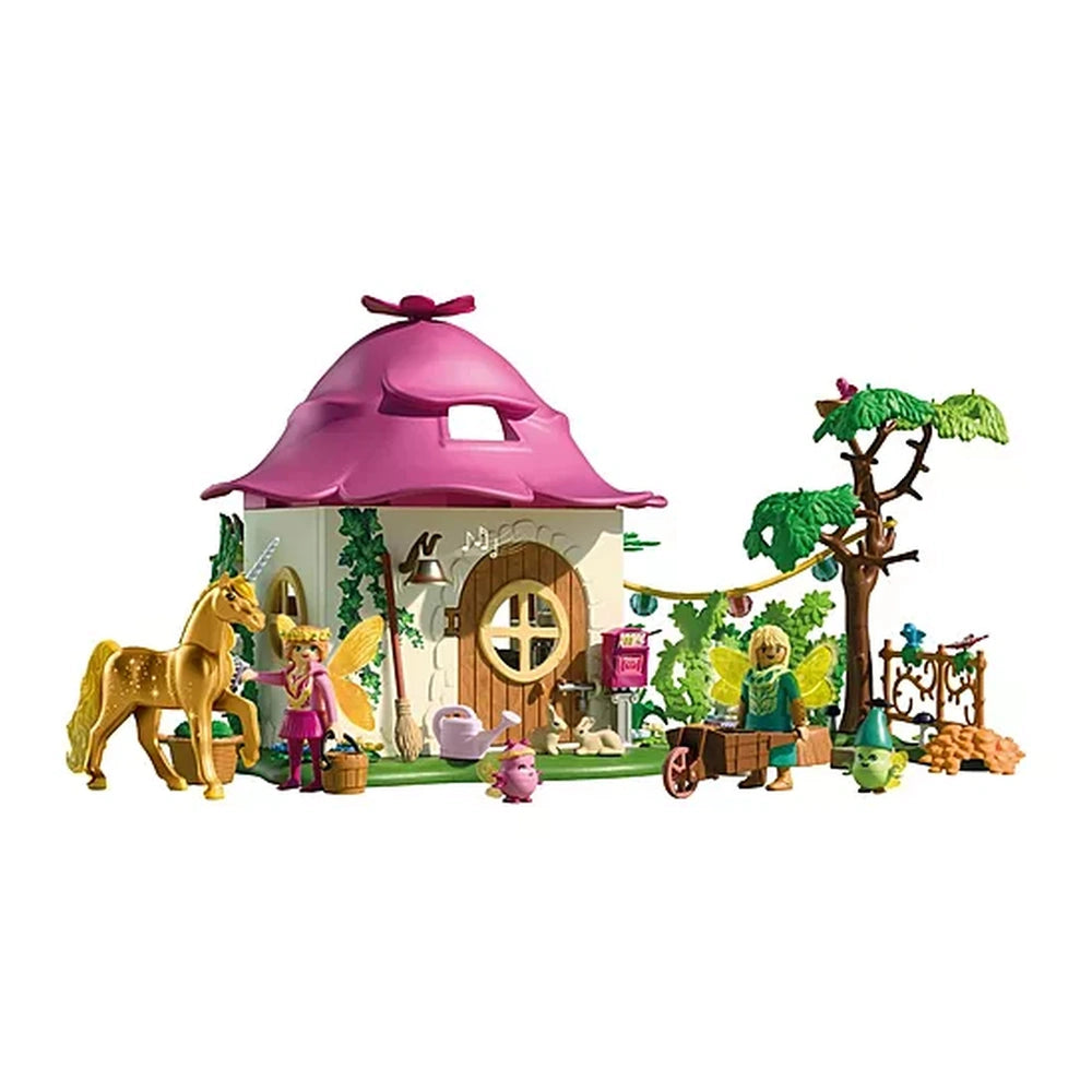 Playmobil Magic Unicorns Cozy Fairy Home with pink roof, white walls, and shiny gold animals in a vibrant green setting.