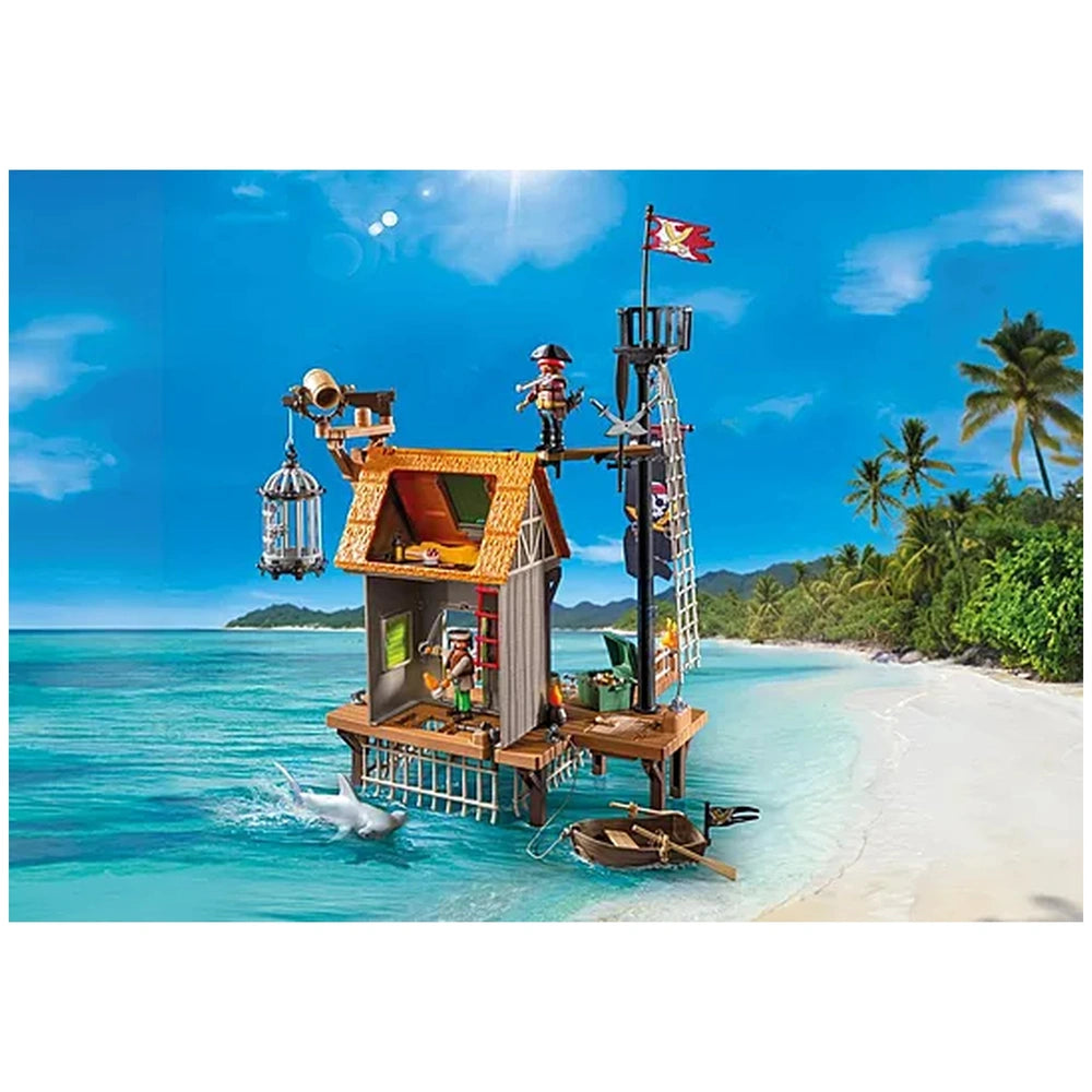 Playmobil Pirate-Harbor toy playset featuring a wooden structure, beach sand, blue water, and figures under a clear sky.