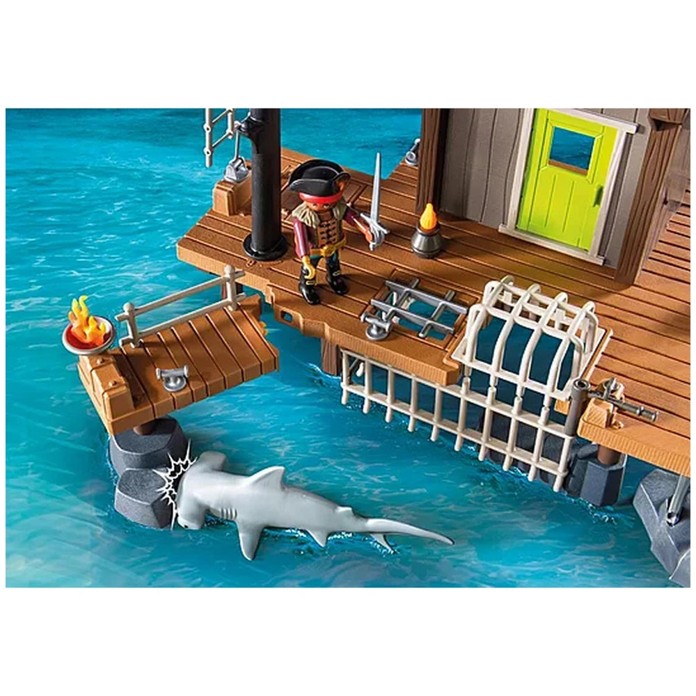 Playmobil Pirate-Harbor toy playset featuring a pirate ship, shark, and accessories on a wooden decking and blue water.