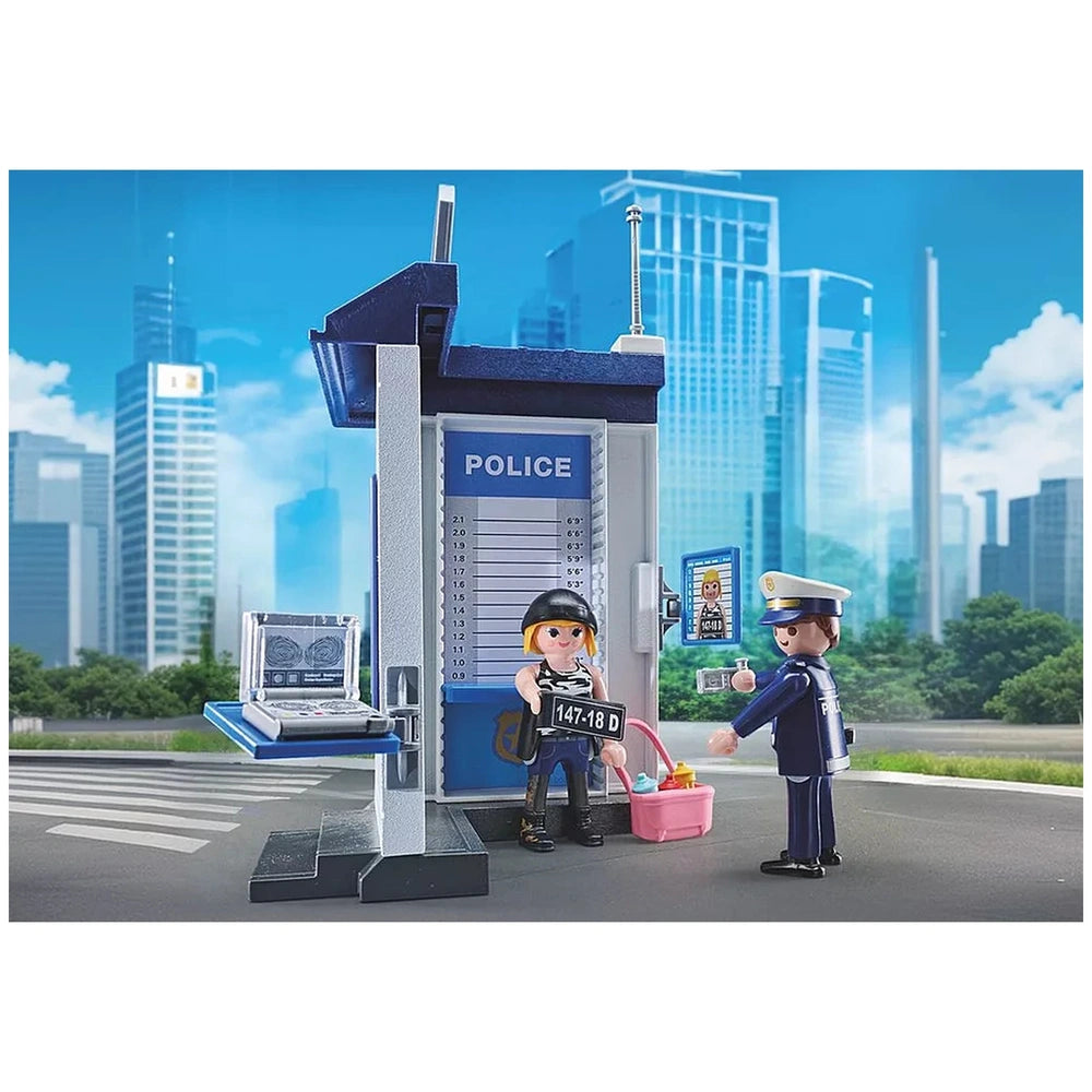 Playmobil Police Interrogation Room features two plastic figures in front of a blue and white police booth with various signs