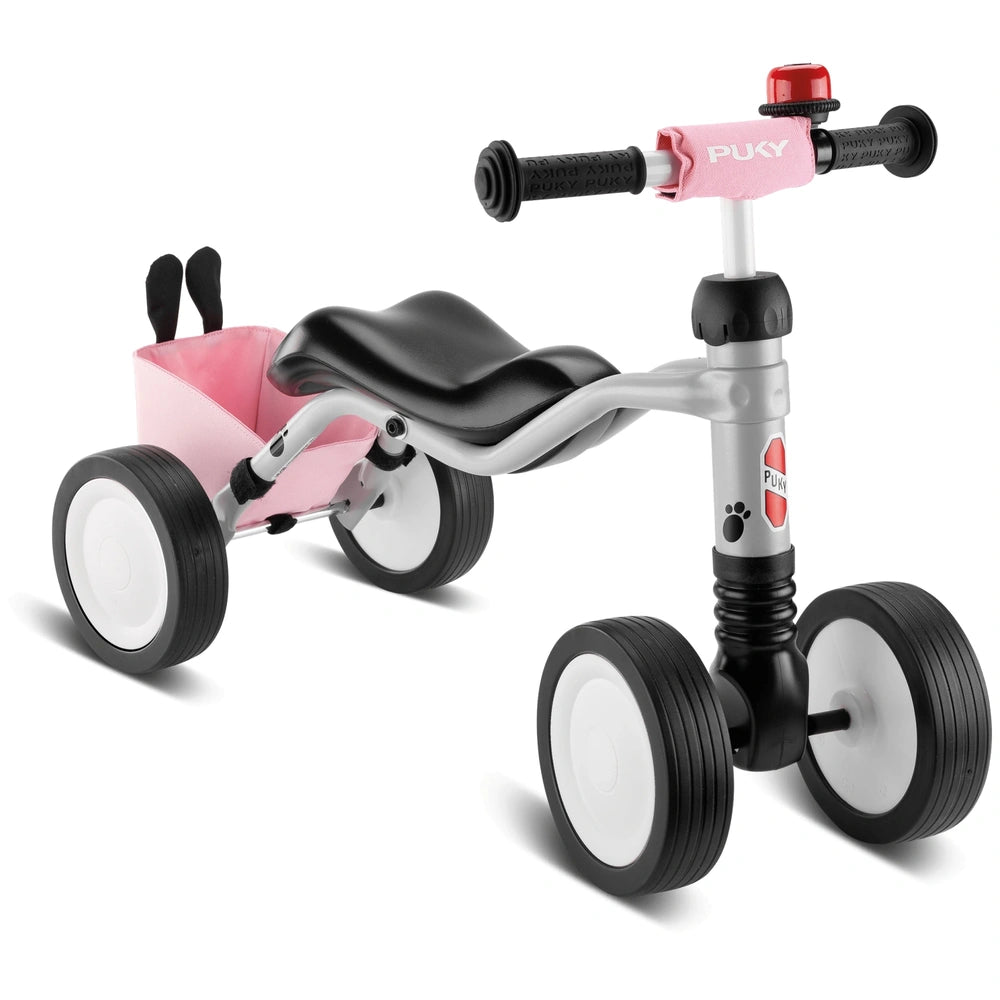Puky Wutsch Bundle quadricycle in pink and gray, featuring a black seat, silver frame, and black wheels with white centers.