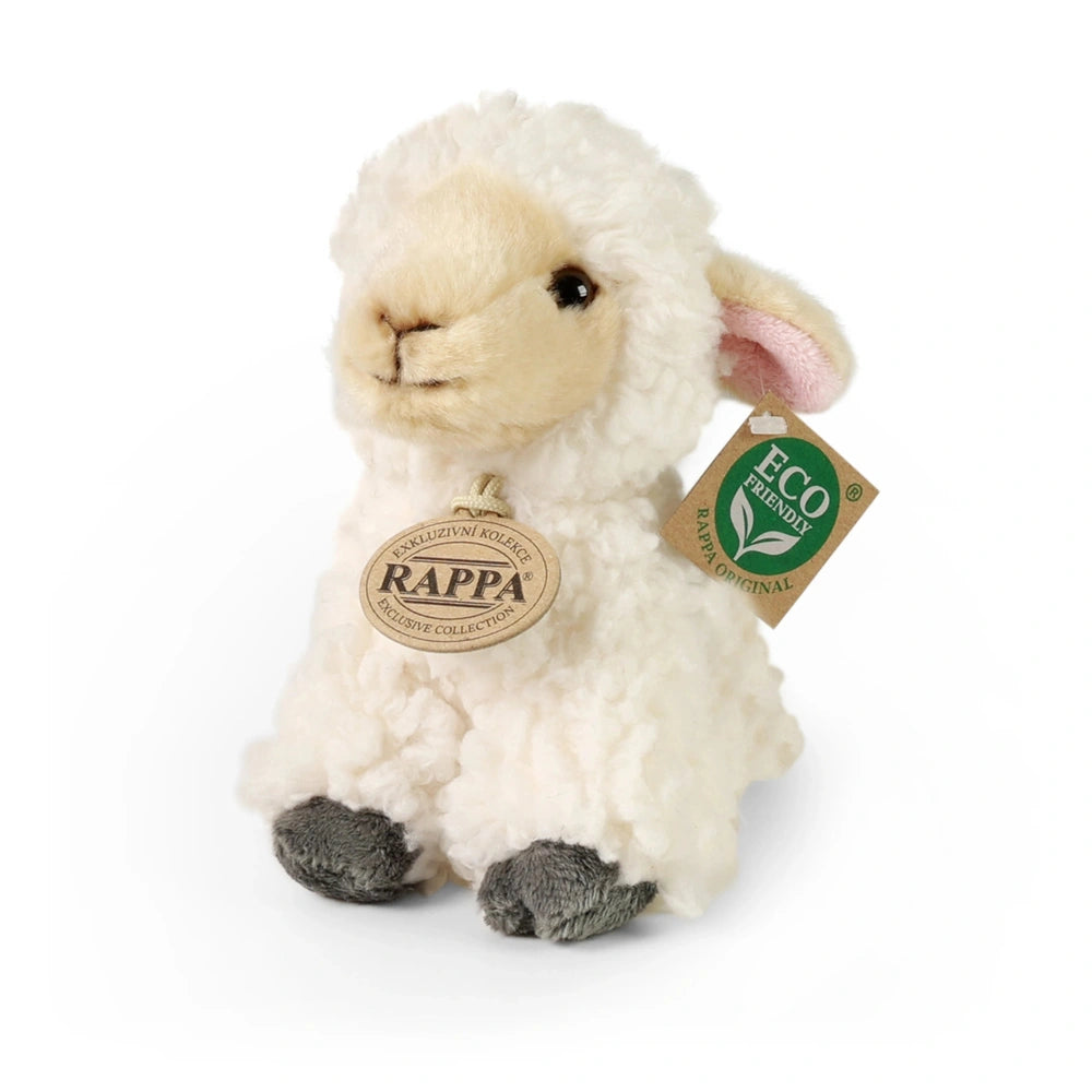 Plush sheep stuffed toy in white and gray, featuring a smiling face and eco-friendly tag, positioned upright against a white 