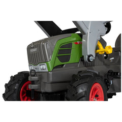 Rolly Farmtrac Fendt 211 Vario tractor in green and grey with a front loader, black tires, and red rims against a white backg
