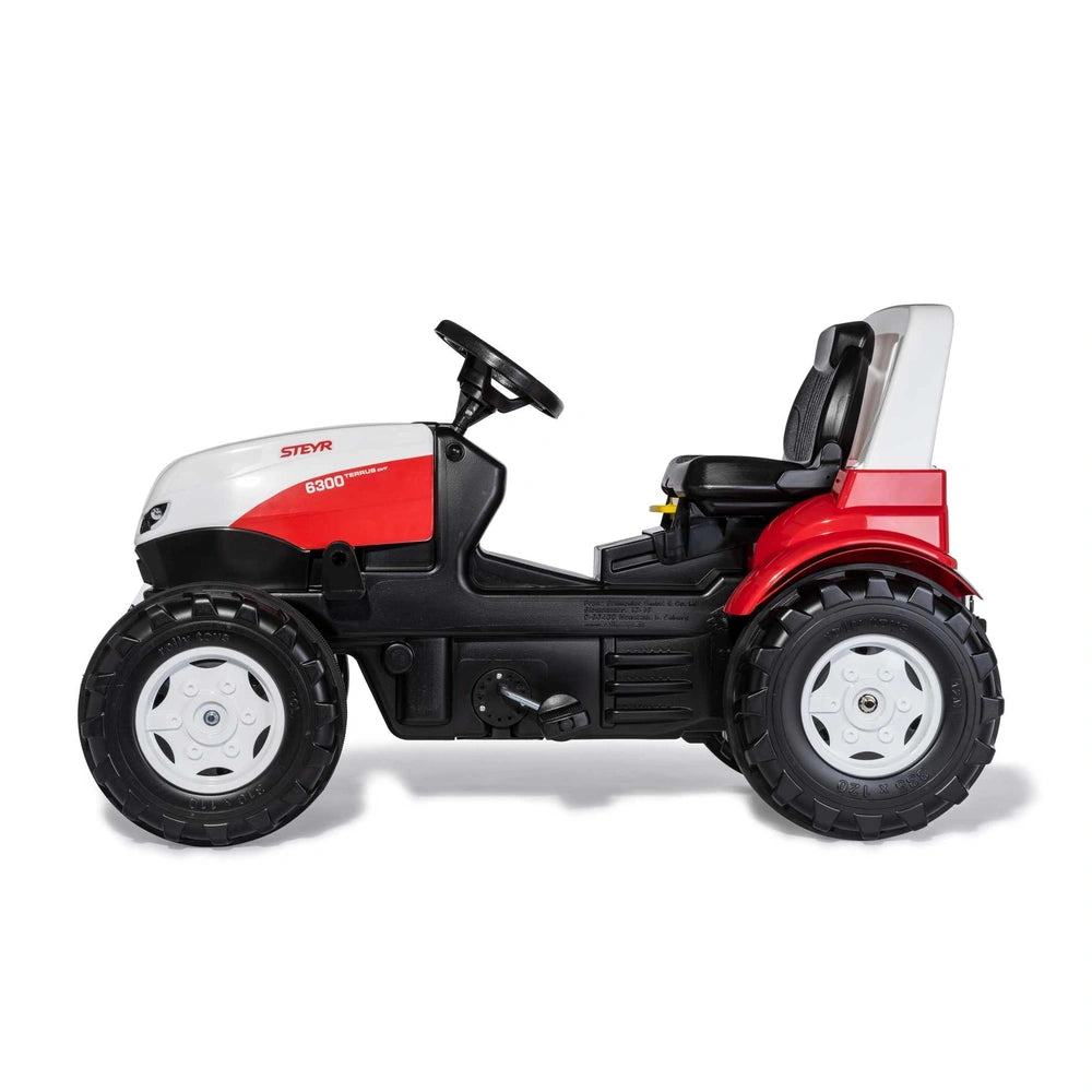 Rollyfarmtrac Premium II Steyr 6300 Terrus CVT riding toy features a black body with red accents and a comfortable seat.