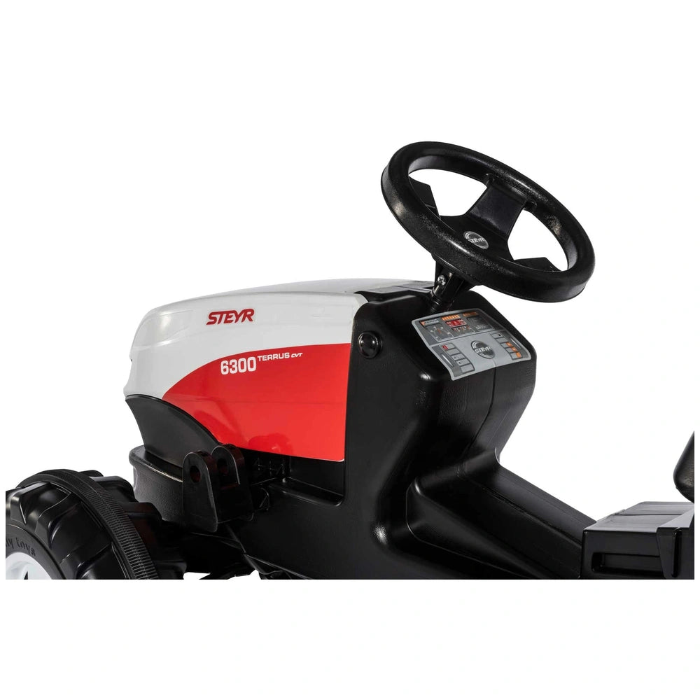 Rollyfarmtrac Premium II Steyr 6300 Terrus CVT riding toy features a glossy red and black design with a large cutting deck an