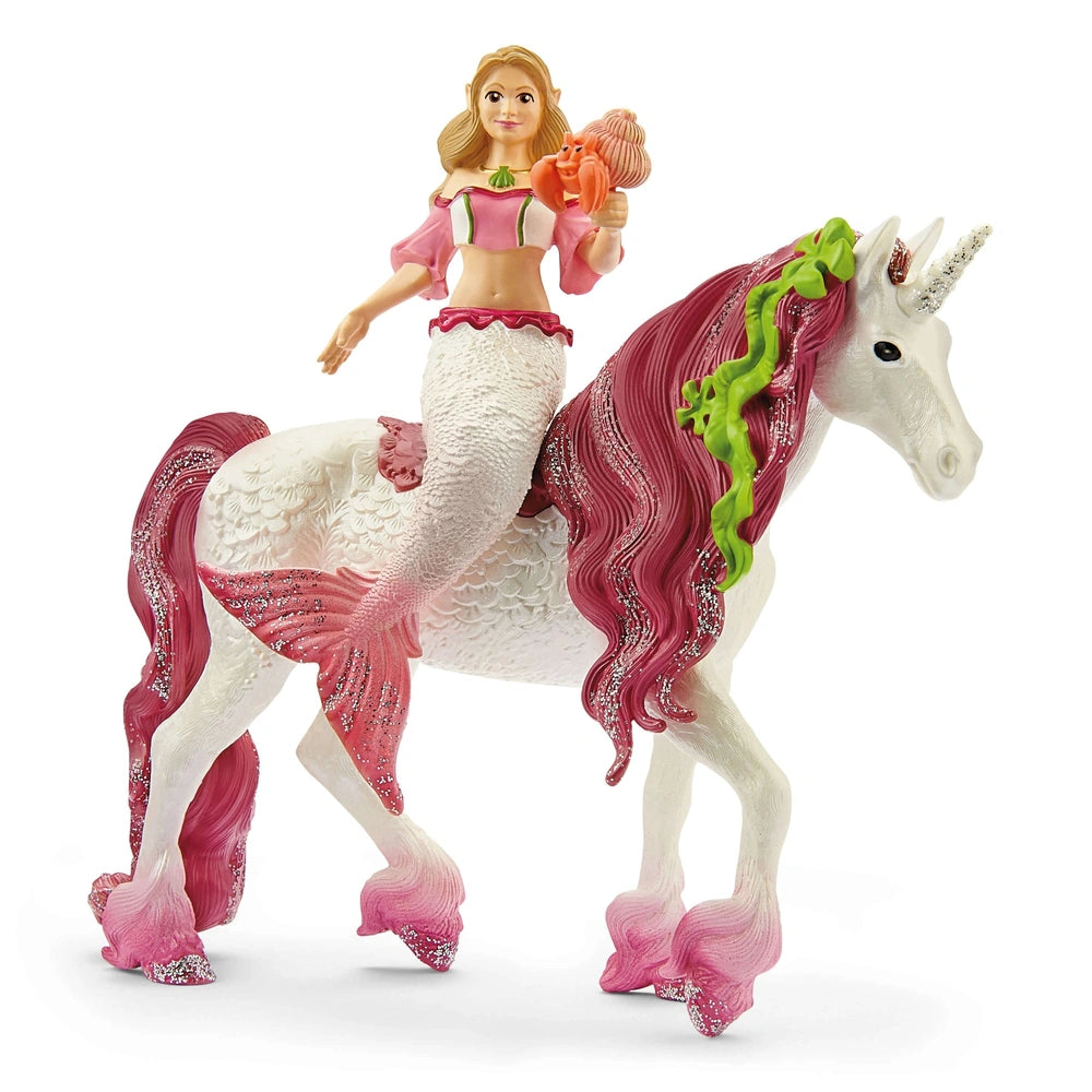 Mermaid Feya rides a pink and white unicorn, holding a pink shell, both made of glossy plastic.