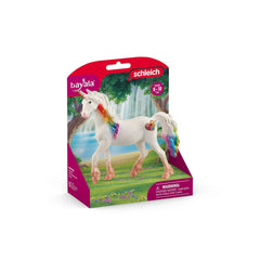 Rainbow Love Unicorn Mare toy in pink packaging with a clear window, showcasing its colorful mane and tail against a grassy b