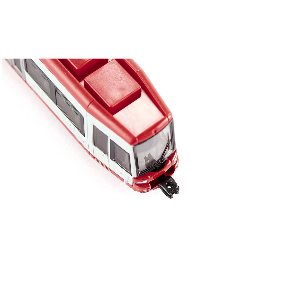 Red and white Bombardier tram toy with shiny plastic surface, clear front window, and visible wheels on a white background.