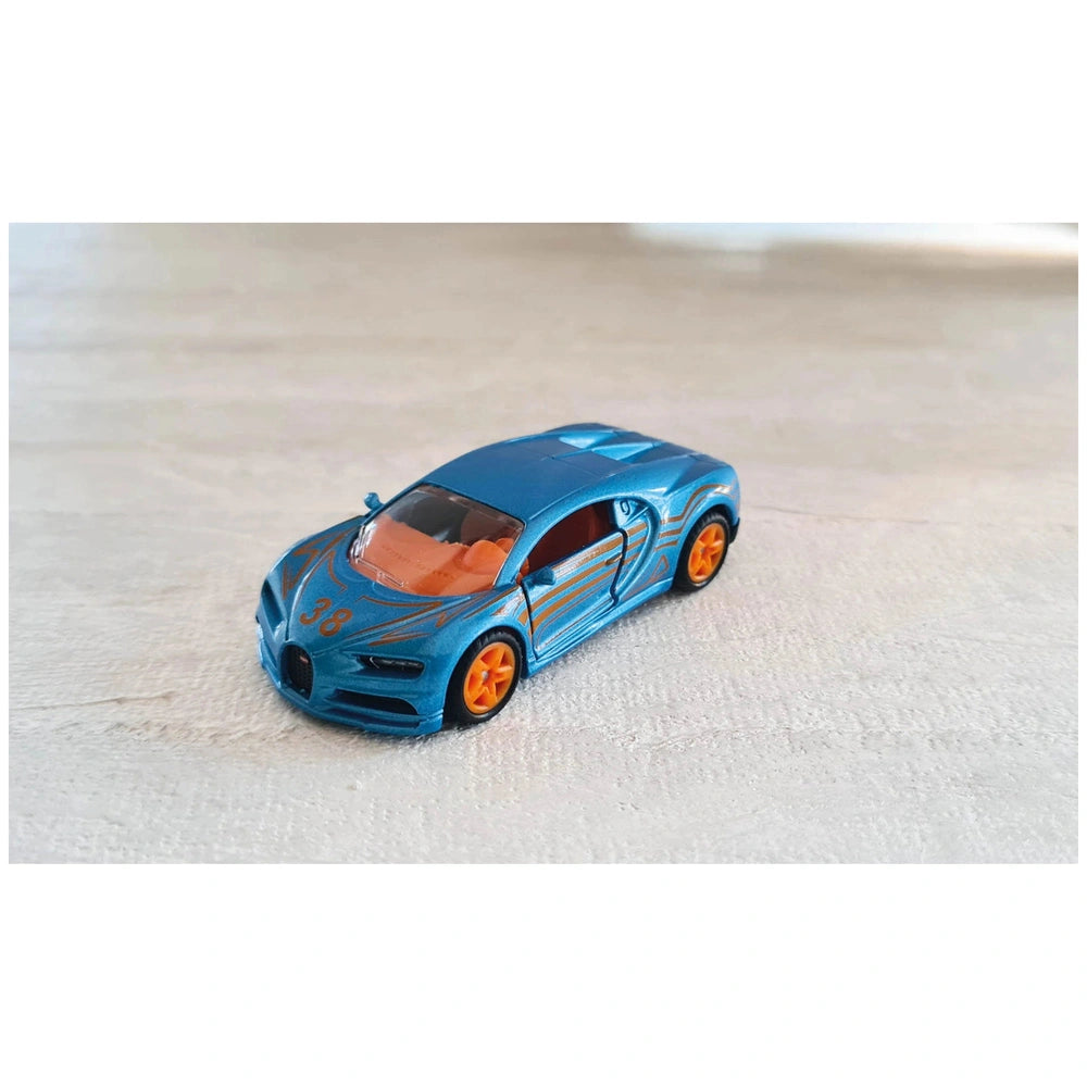 Siku Bugatti Chiron toy car features a blue body with orange accents and a black roof, placed on a light-colored surface.