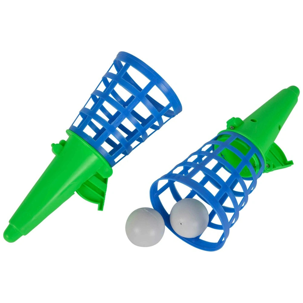 Simba Catchball game set featuring green plastic catchers with blue lids and two white balls for outdoor play.