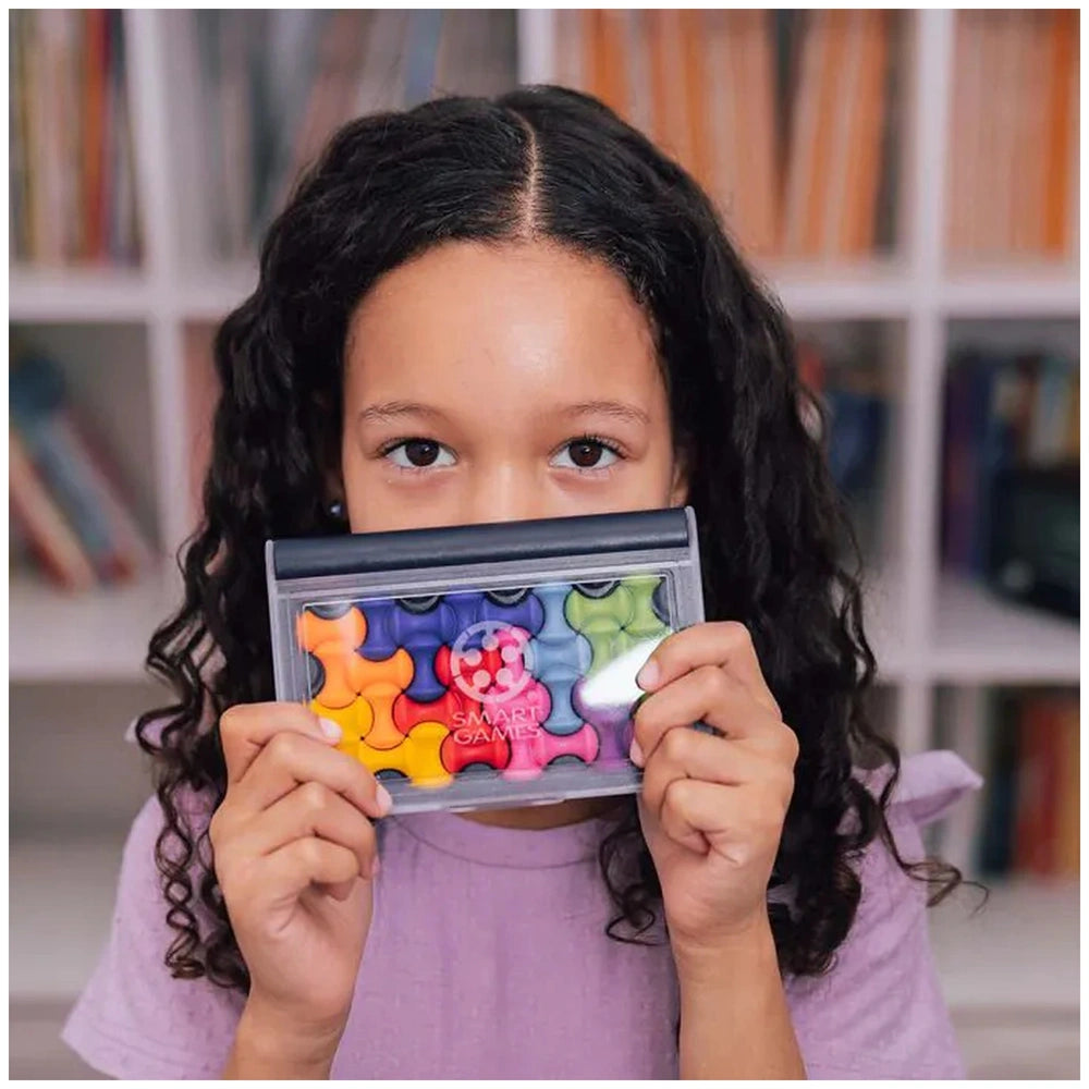 Smart Games - IQ Waves logic puzzle container held by a young girl in a purple shirt, featuring a colorful patterned lid.
