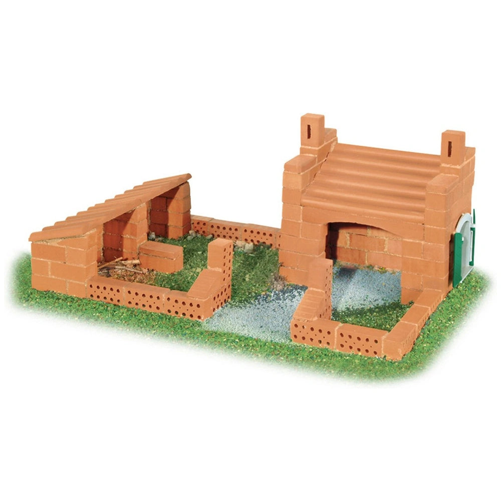 Teifoc Castle-House model features a reddish-brown brick structure with a bright green roof and small green plants around it.