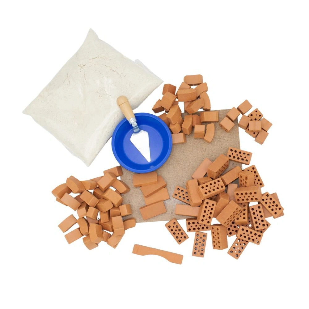Teifoc castle kit with a blue lid, white surface, and scattered brown rectangular pieces for arts and crafts.