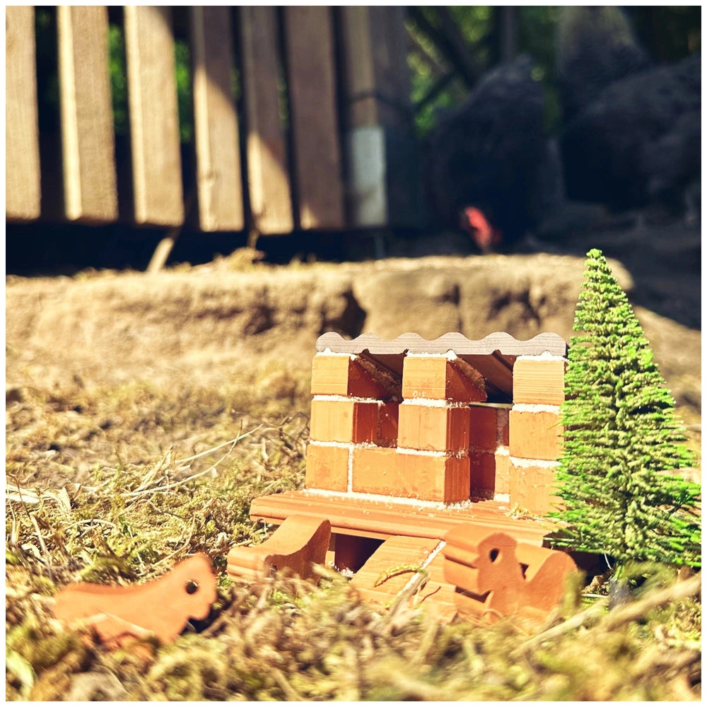 Teifoc chicken coop features a handcrafted wooden structure in a rural setting with an artificial green tree in front.