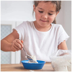 Teifoc water-soluble mortar is showcased alongside a young girl enjoying food from a blue bowl at a wooden table.
