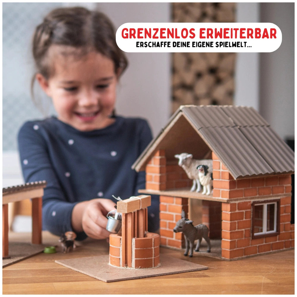 Teifoc well set with a young girl at a wooden table, featuring cardboard materials and plastic figurines in a playful scene.