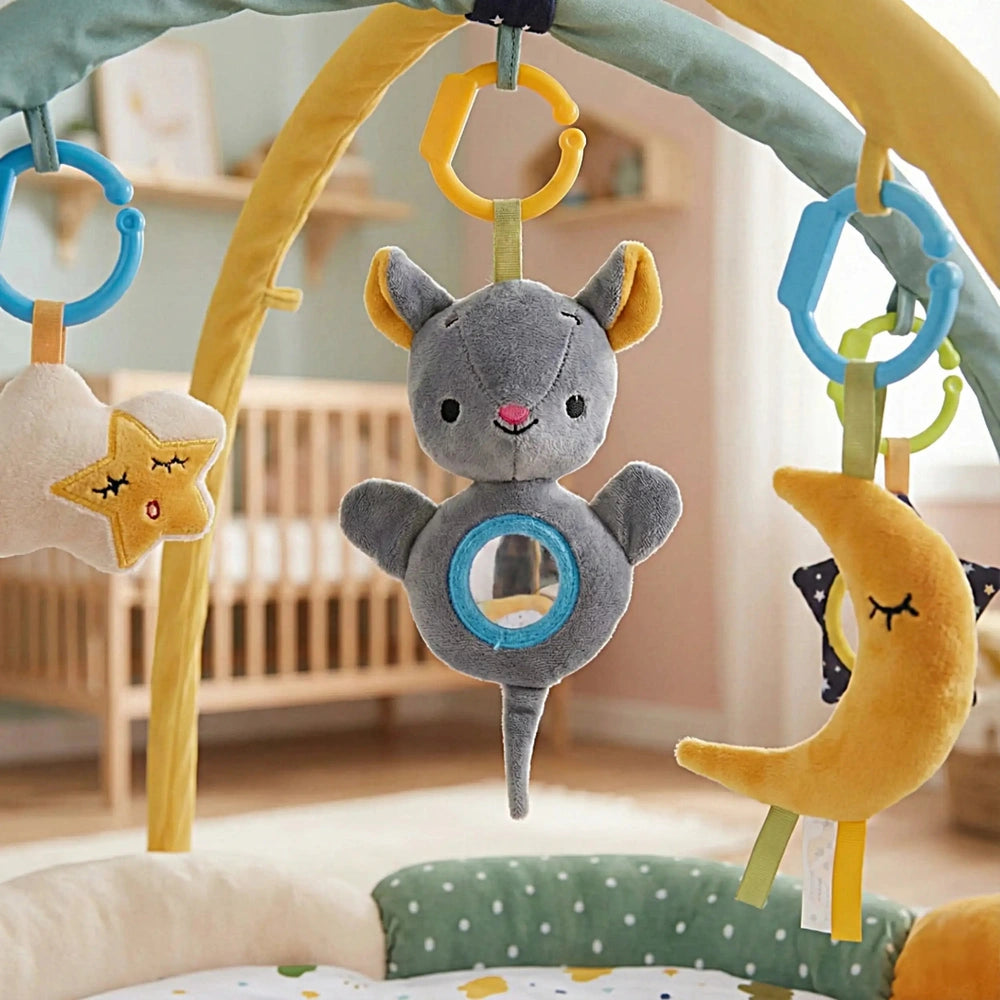 Teorema GoGO Soft Play Gym with Toy Bar is set in a light blue child's bedroom with plush toys hanging from a whimsical crib 