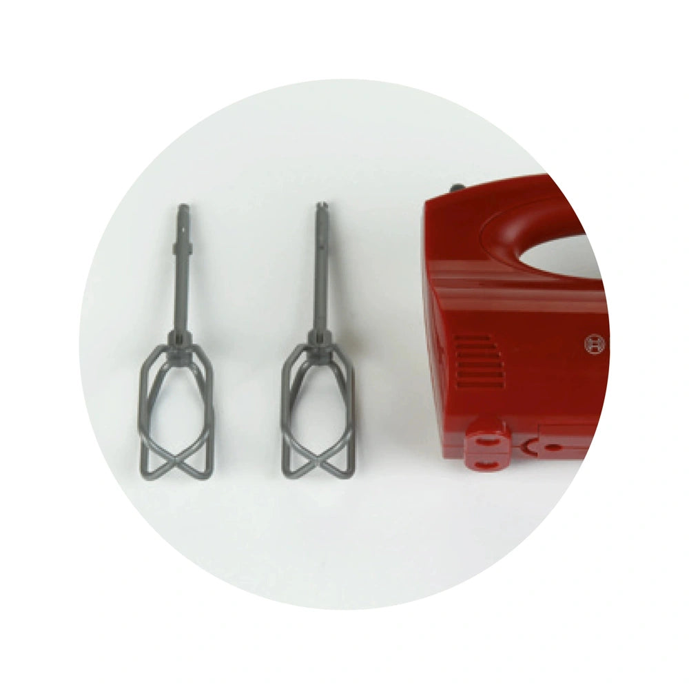 Theo Klein Bosch handmixer in red and gray with two metal tongs showcased against a red background.