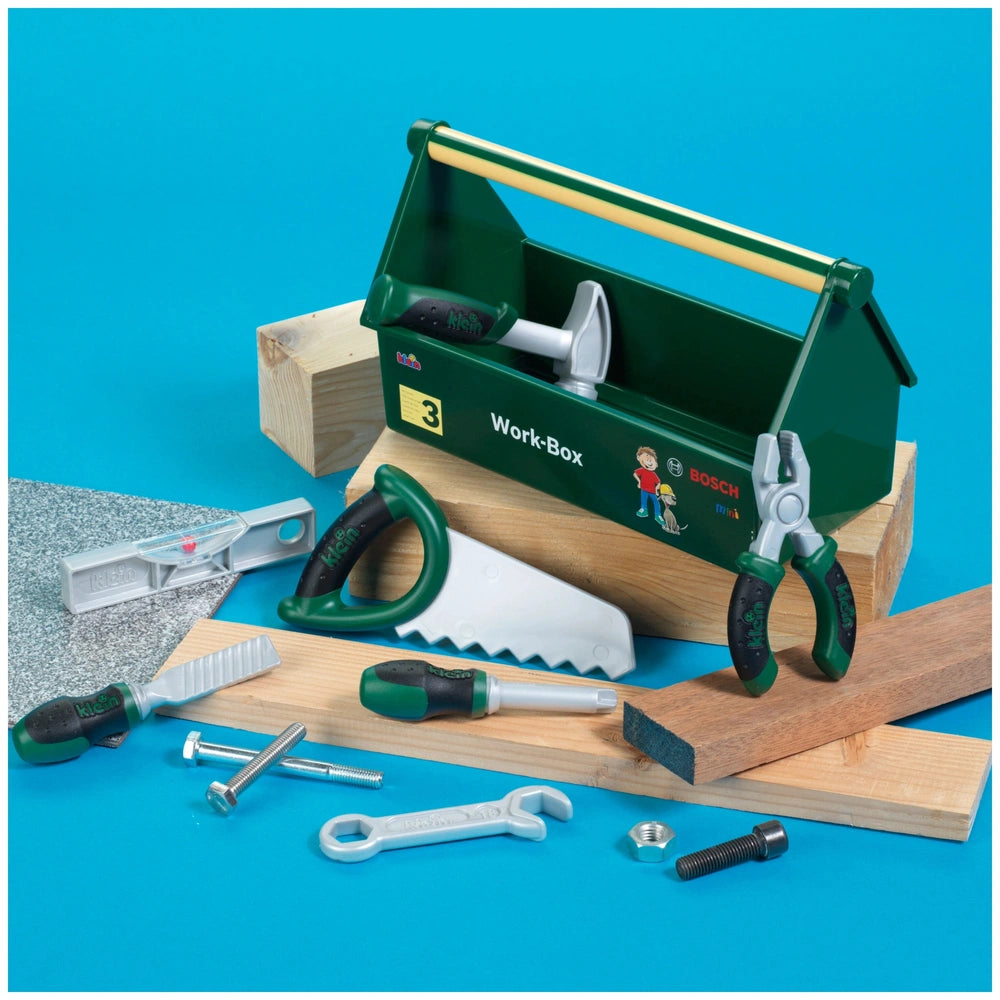 Theo Klein Bosch work box featuring a green plastic toolbox, wooden planks, and metal tools like a screwdriver and hammer.