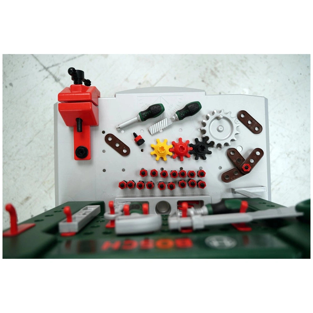 Theo Klein Bosch workbench with 77 pieces, featuring metallic green surface and various colored screws and a red-handled scre