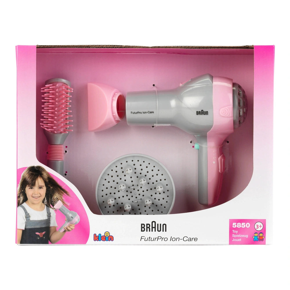 Theo Klein Braun hairdryer set with diffuser and brush in pink cardboard packaging, featuring plastic components.